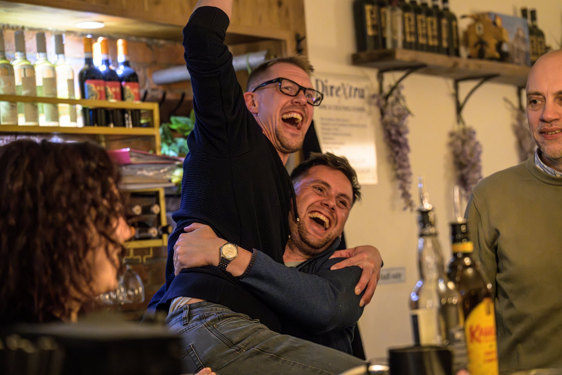 Team during a corporate cocktail masterclass in Manchester, having fun while learning mixology techniques