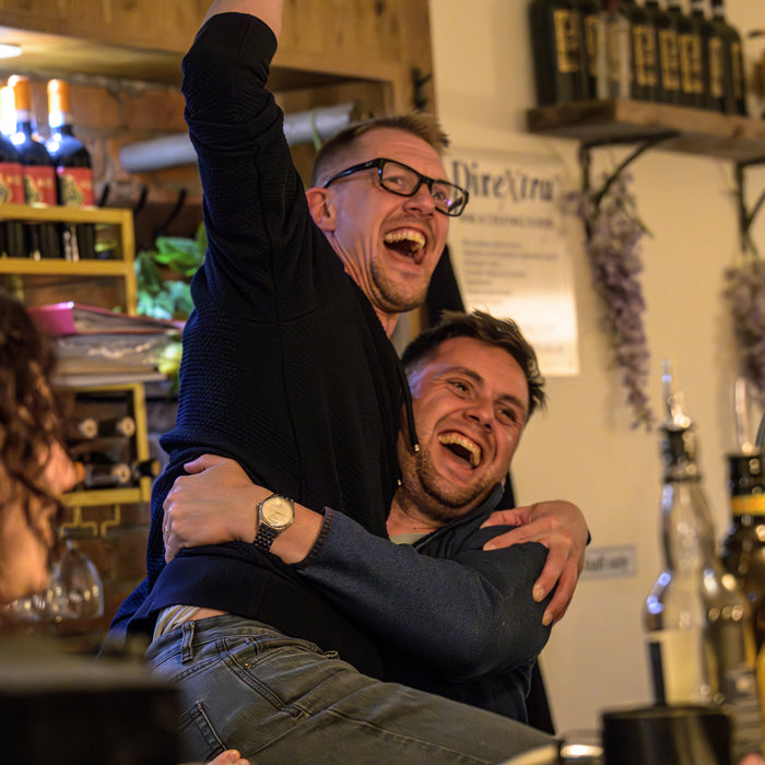 Team during a corporate cocktail masterclass in Manchester, having fun while learning mixology techniques