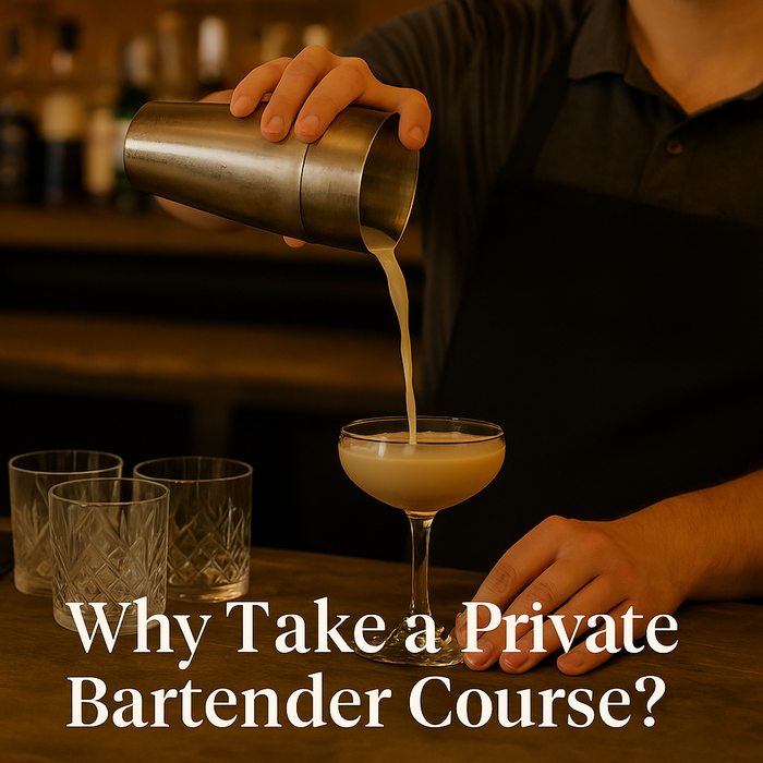 A bartender in training pouring a cocktail while receiving one-on-one instruction behind a bar in Manchester.