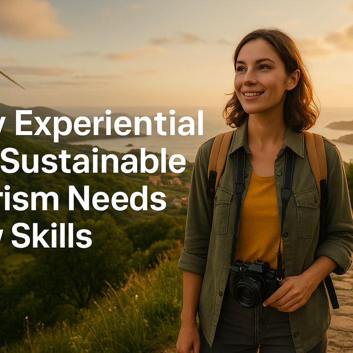 Young tourism professional standing on a stone path at sunset, overlooking green hills, a bay, and a wind turbine — representing the evolution of sustainable tourism.